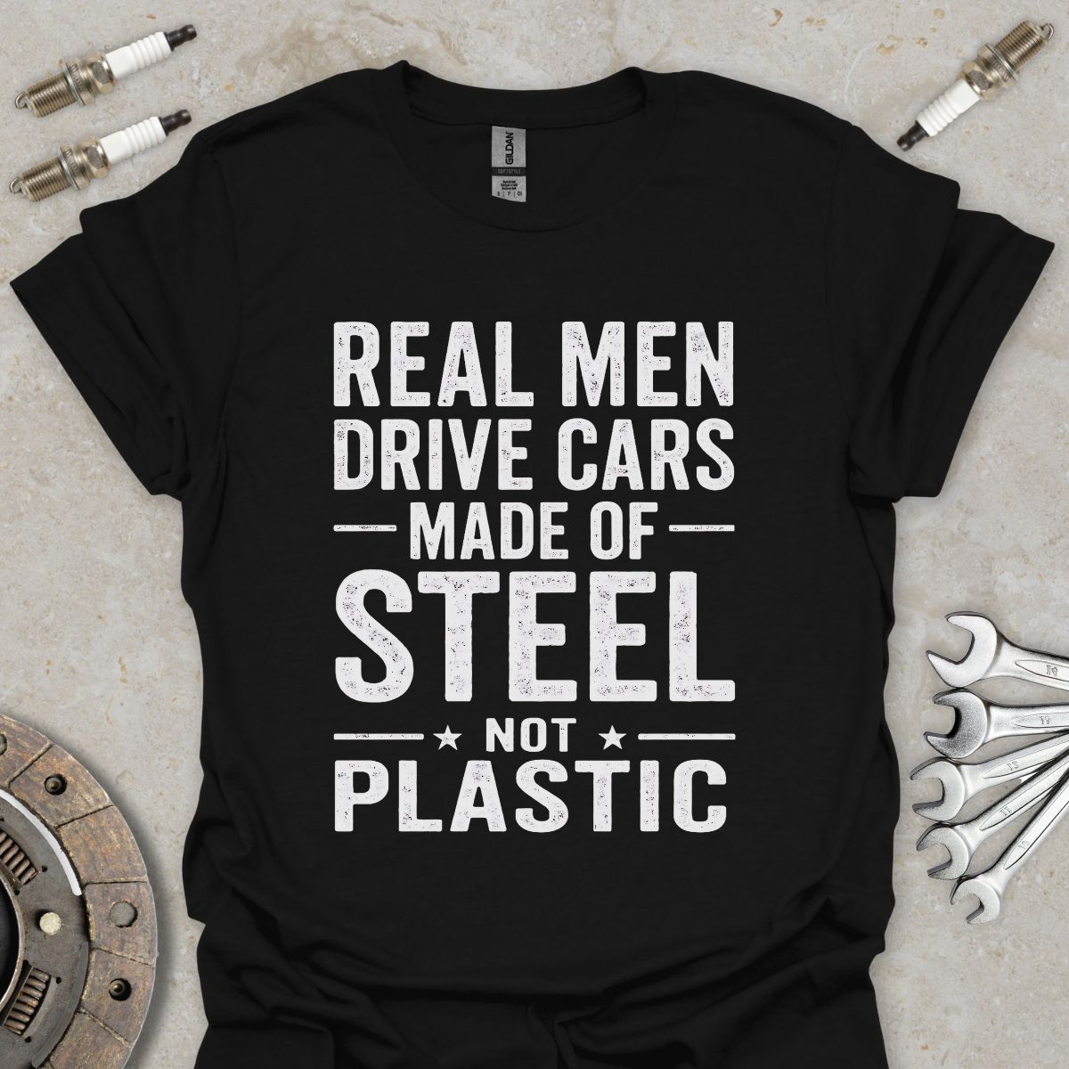 Real Men drive Cars made of Steel not Plastic  T-Shirt