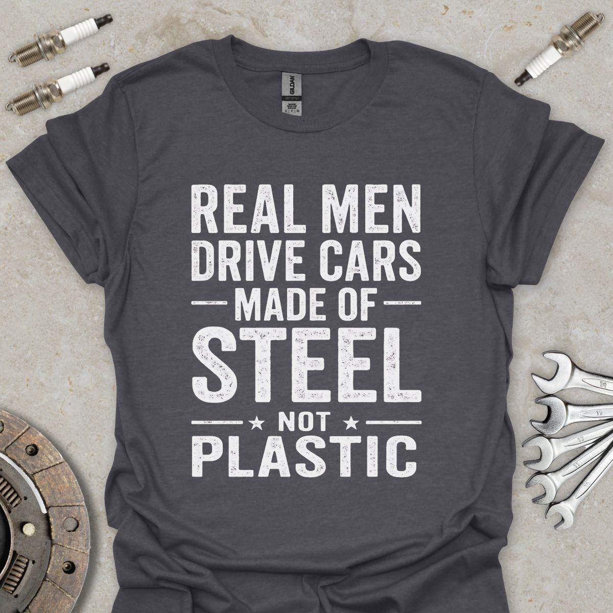 Real Men drive Cars made of Steel not Plastic  T-Shirt