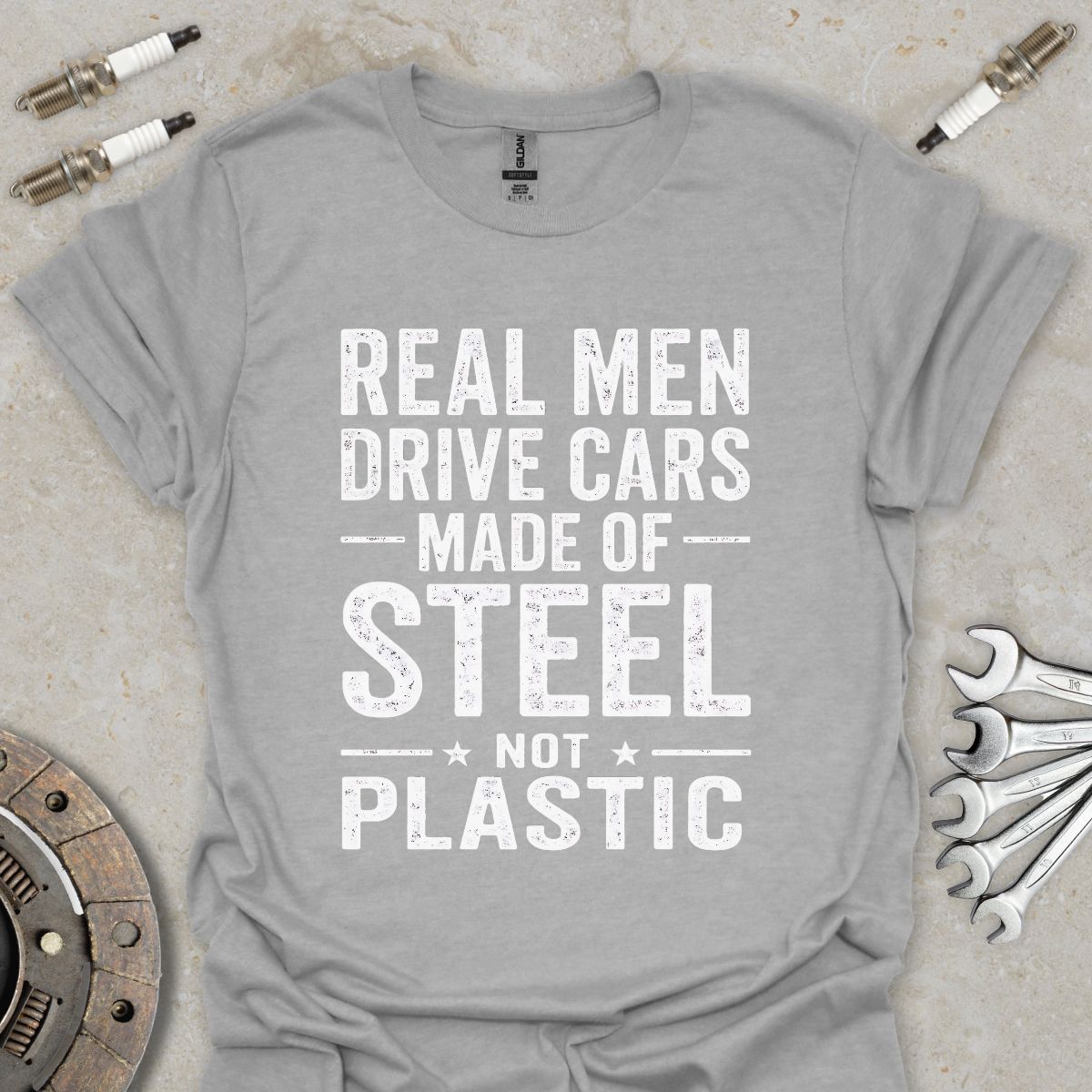 Real Men drive Cars made of Steel not Plastic  T-Shirt